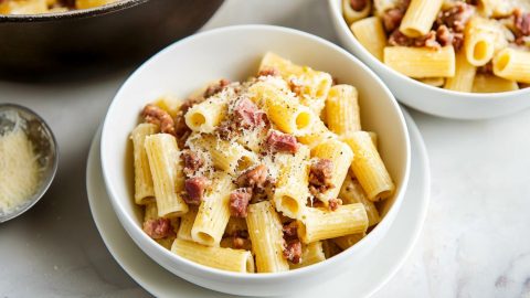 Bowls of rigatoni pasta alla gricia with pork guanciale, black pepper and grated cheese.