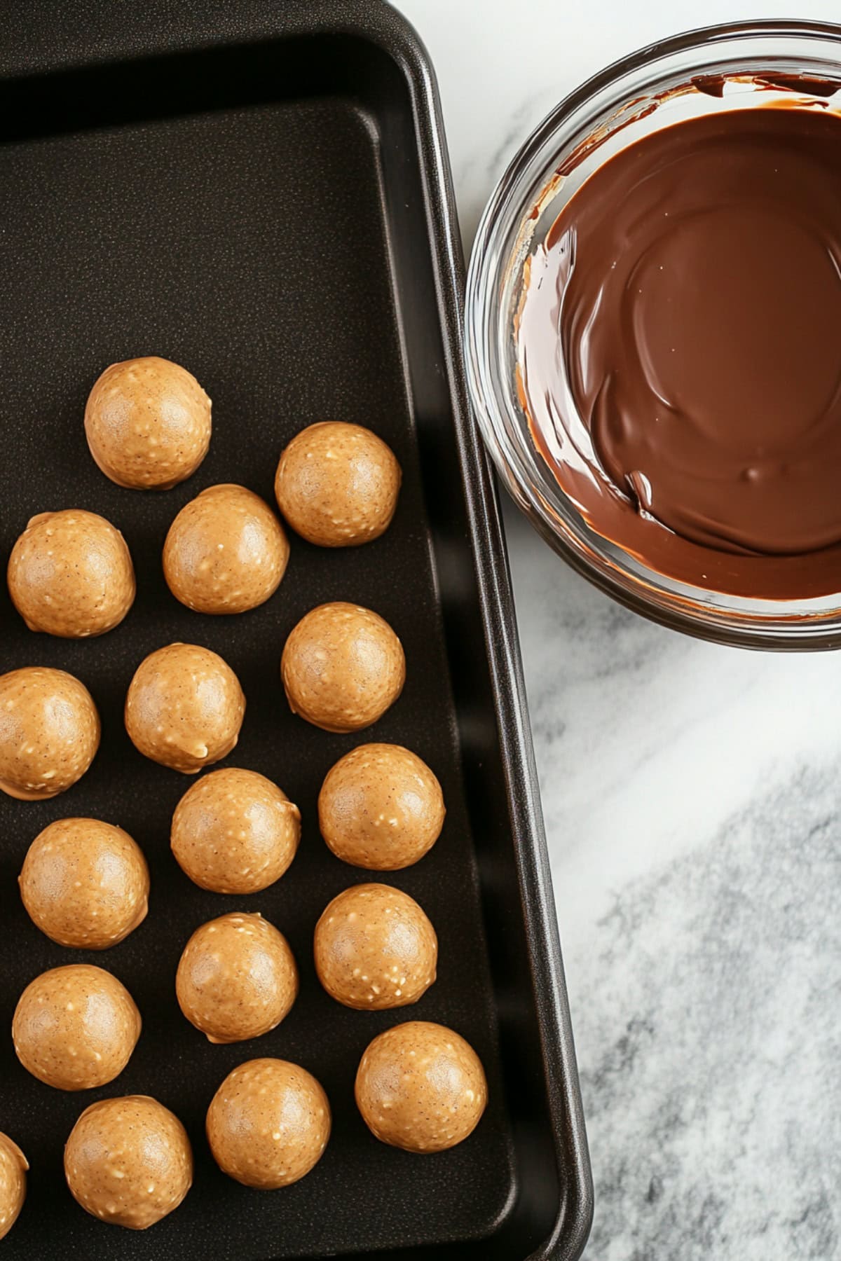 Peanut Butter Cake Pops on a Baking Tray with Melted Chocolate