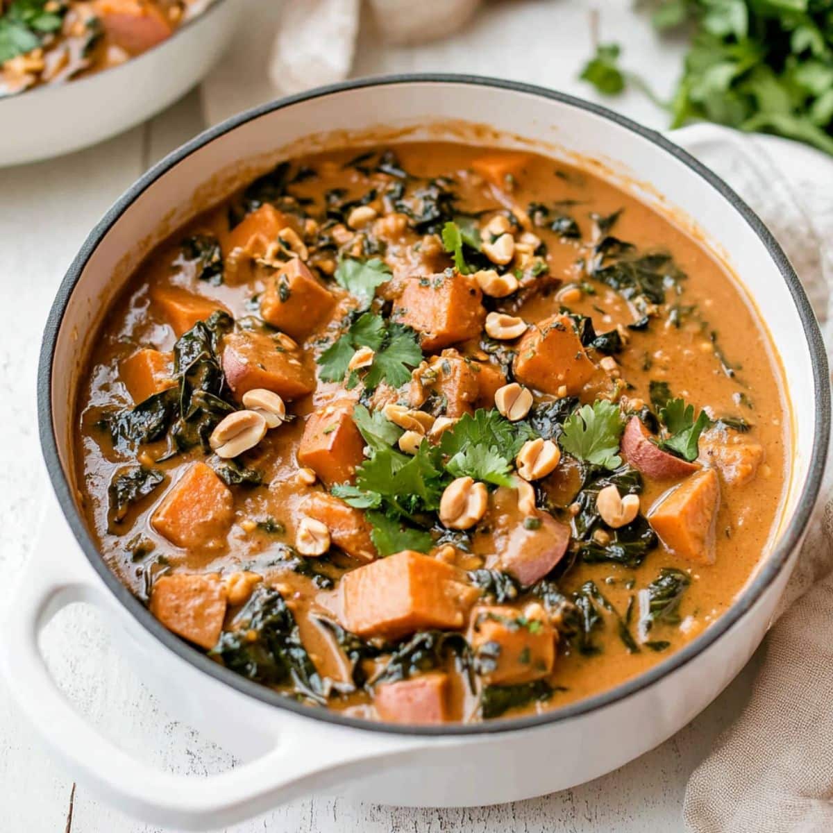 Peanut butter soup cooked in a Dutch oven pot.