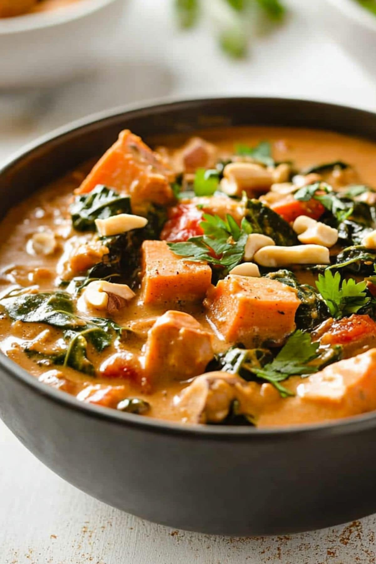 Peanut butter soup with sweet potatoes sliced in cubes, clolard greens in creamy peanut sauce.