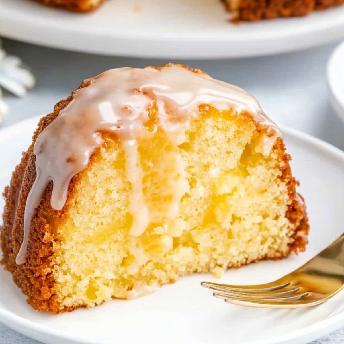 Slice of pineapple cream cheese pound cake served in a plate.