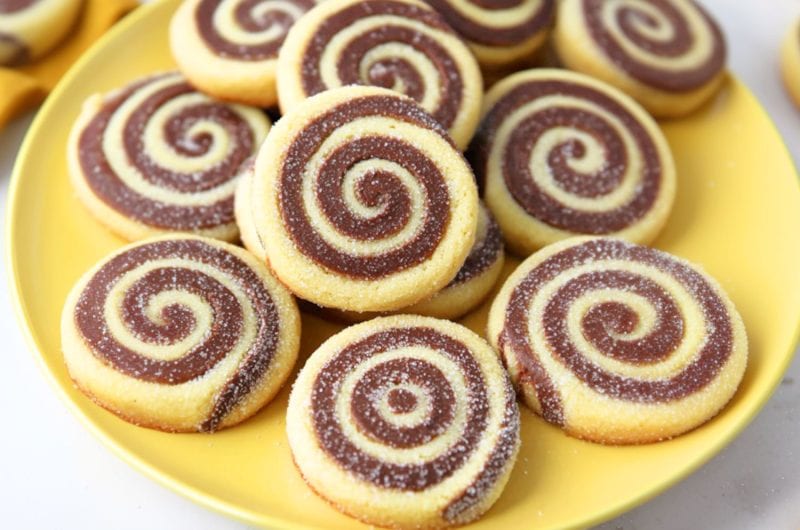 Bunch of pinwheel cookies served in a yellow plate.