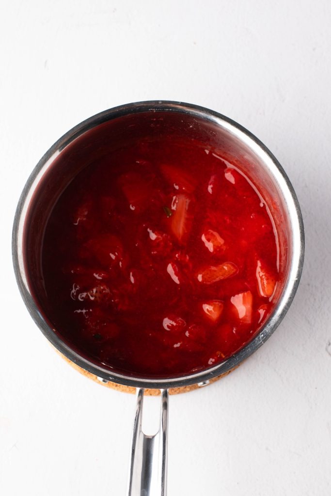 Homemade strawberry sauce in a saucepan, top view