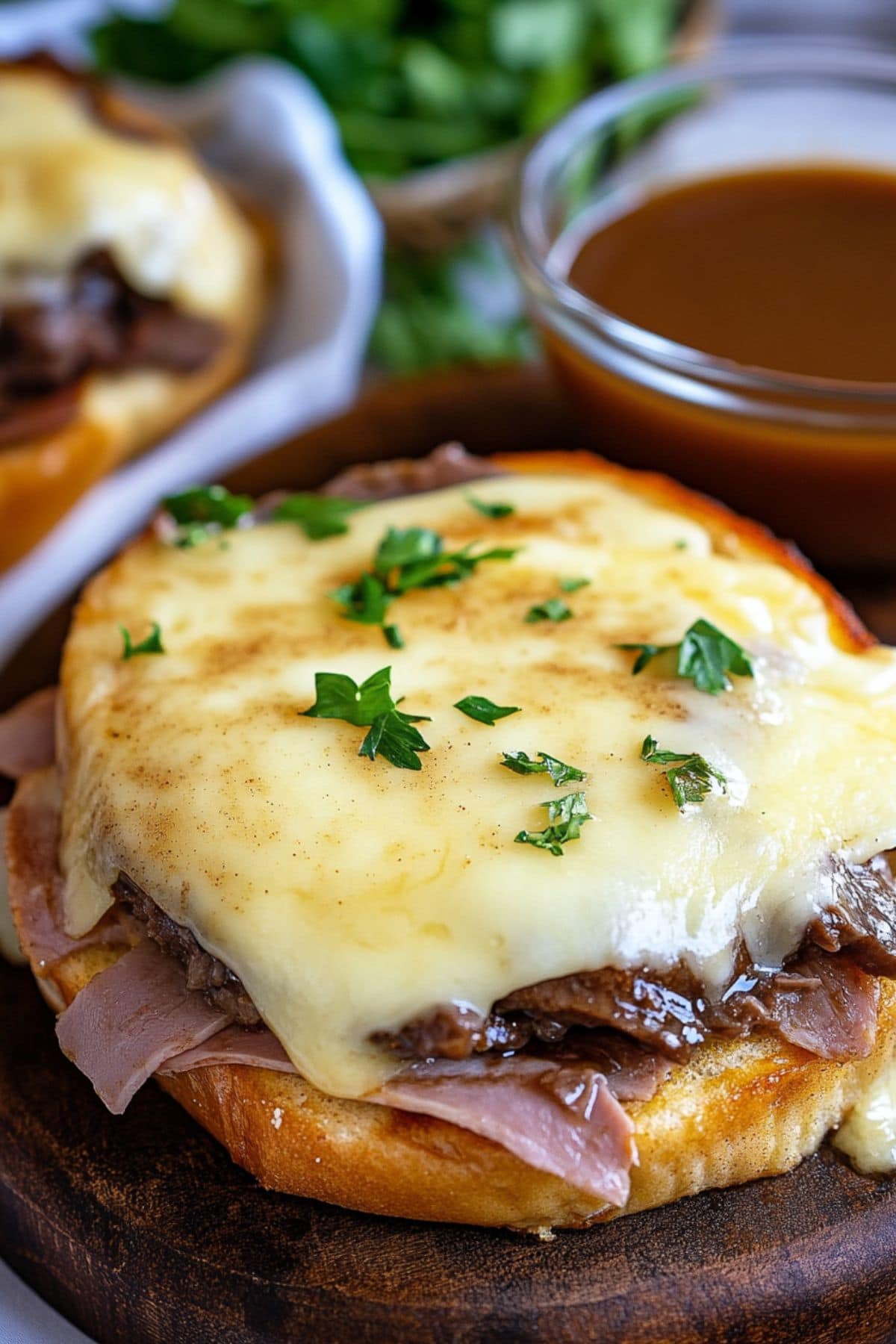 Texas French toast bread topped with deli roast beef and melted cheese served with bowl of gravy on the side.