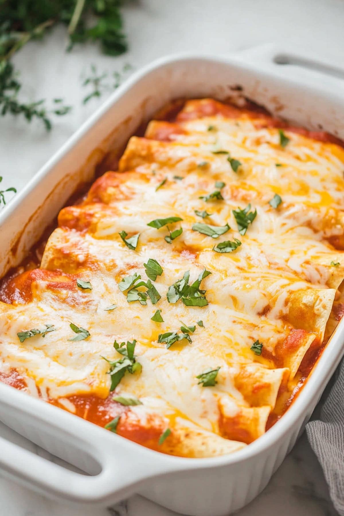 Casserole dish with homemade cheesy enchiladas.