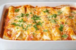 Cheese enchiladas in a baking dish.