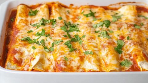 Cheese enchiladas in a baking dish.