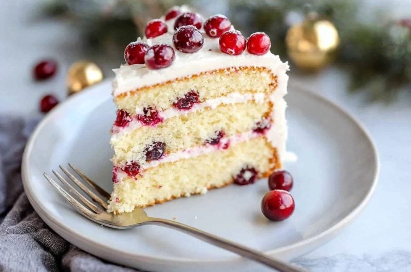 Rich and creamy cranberry orange cake in a plate.