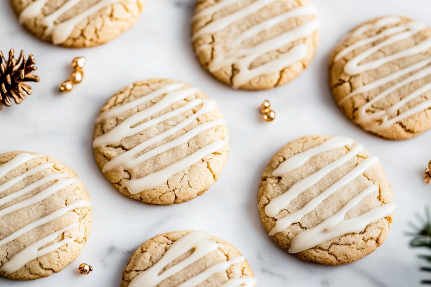 A batch of golden-brown eggnog snickerdoodles arranged in a cooling rack.