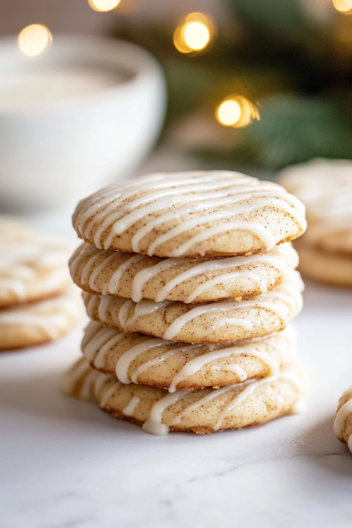 A stack of freshly baked eggnog snickerdoodles with glaze, side view