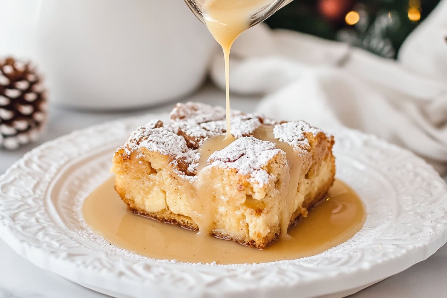 Bread pudding in an elegant plate with drizzled with creamy sauce.