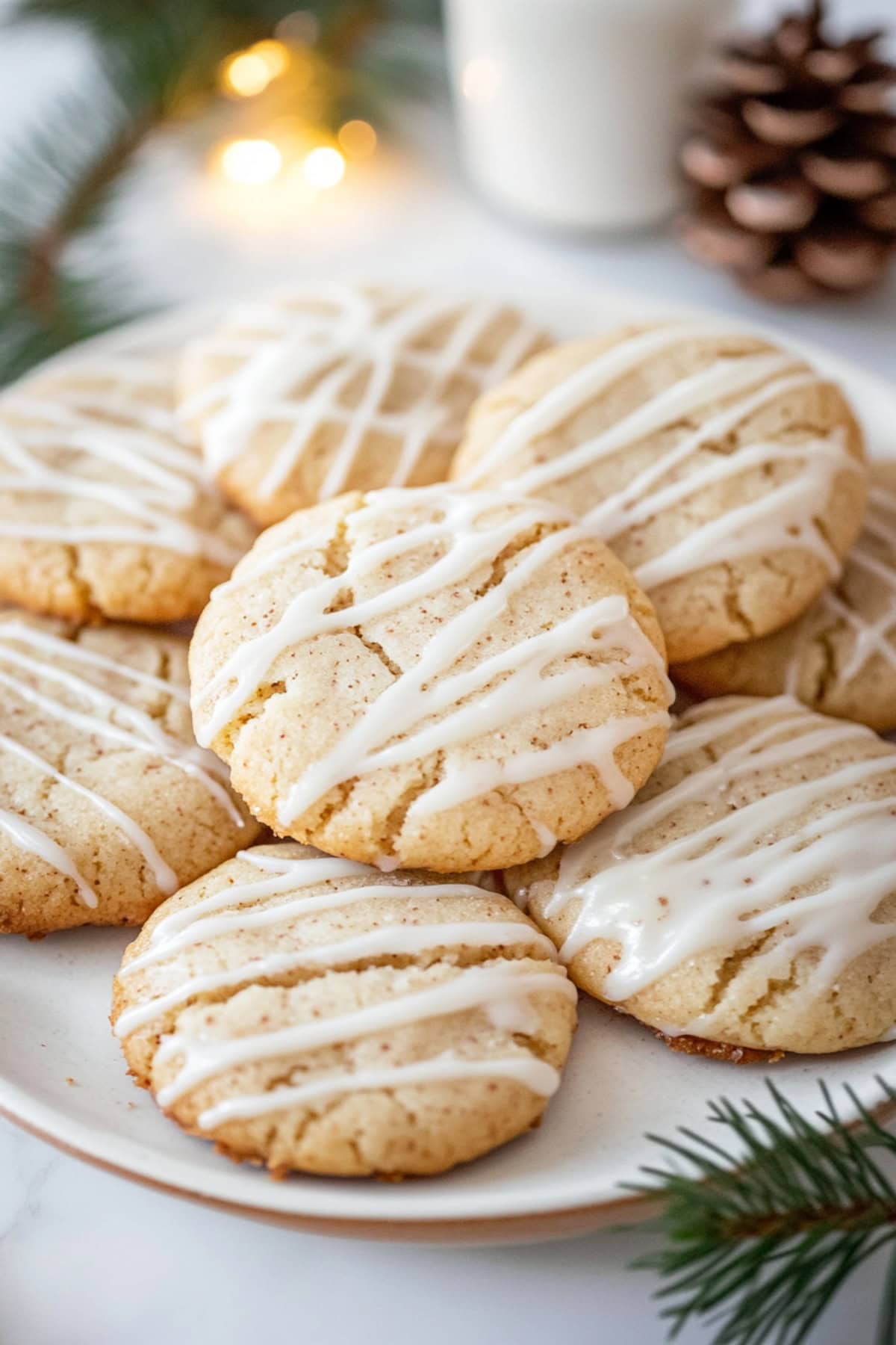 A close-up shot of eggnog snickerdoodles with glaze on a plate.