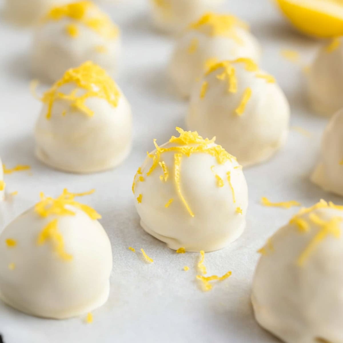 Lemon oreo truffles in a baking pan with parchment paper.