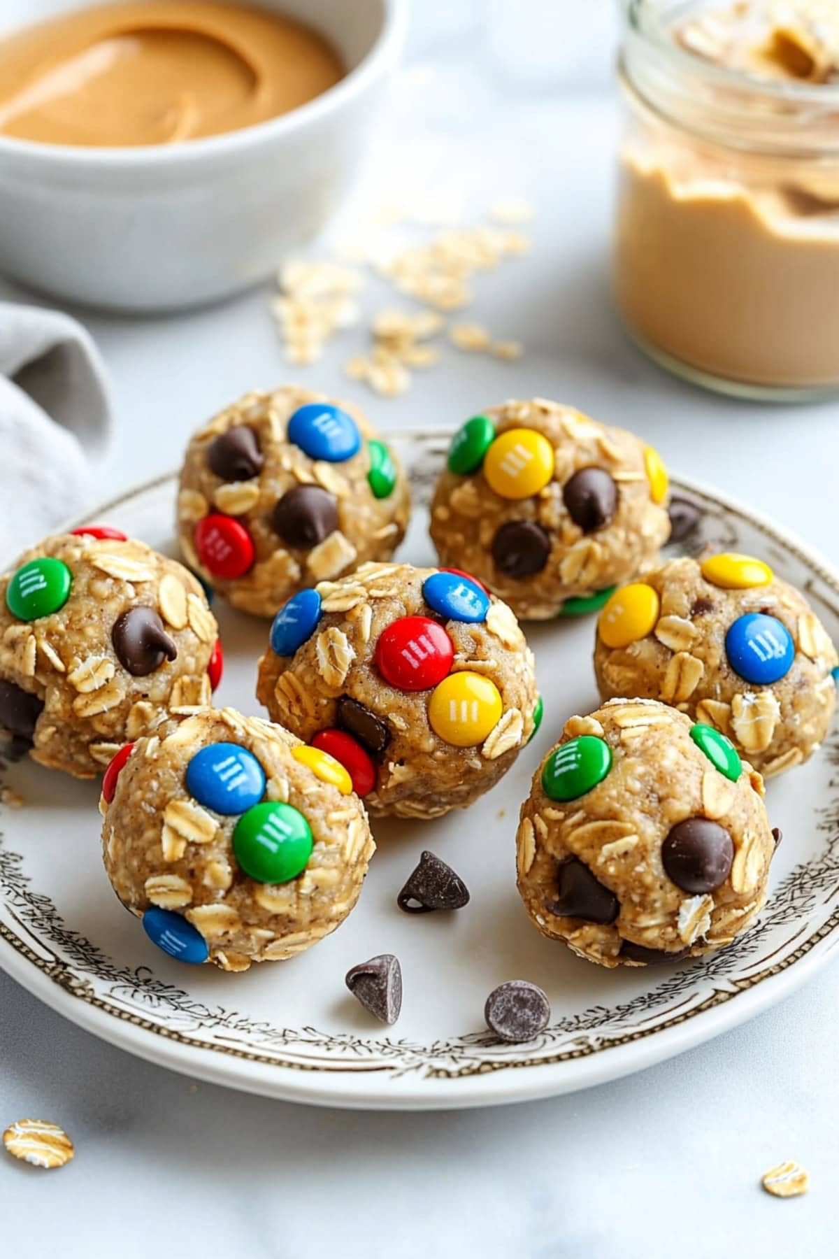 Monster cookie balls made with oats, chocolate chips, M&Ms, and peanut butter, rolled into bite-sized treats.