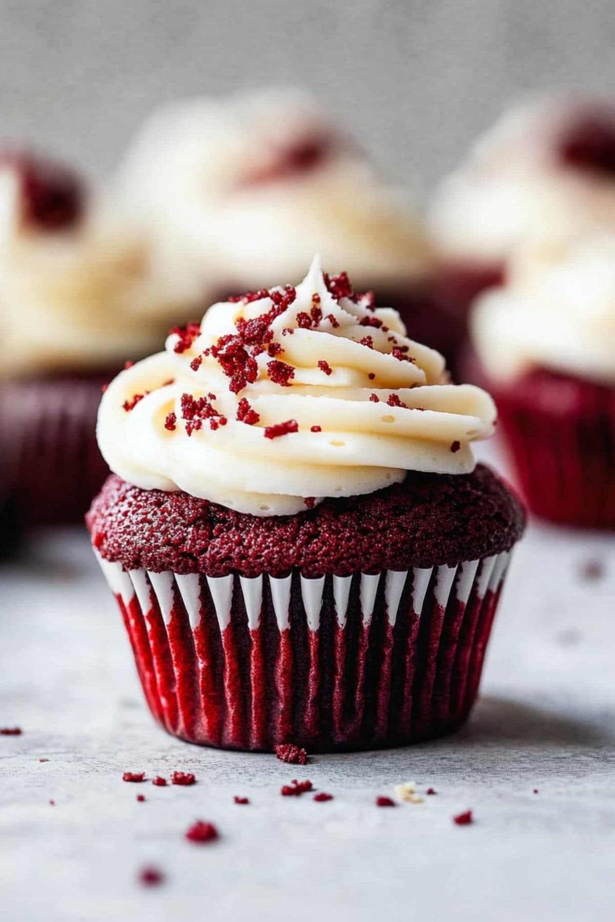 A piece of homemade red velvet cupcakes with cream cheese frosting.