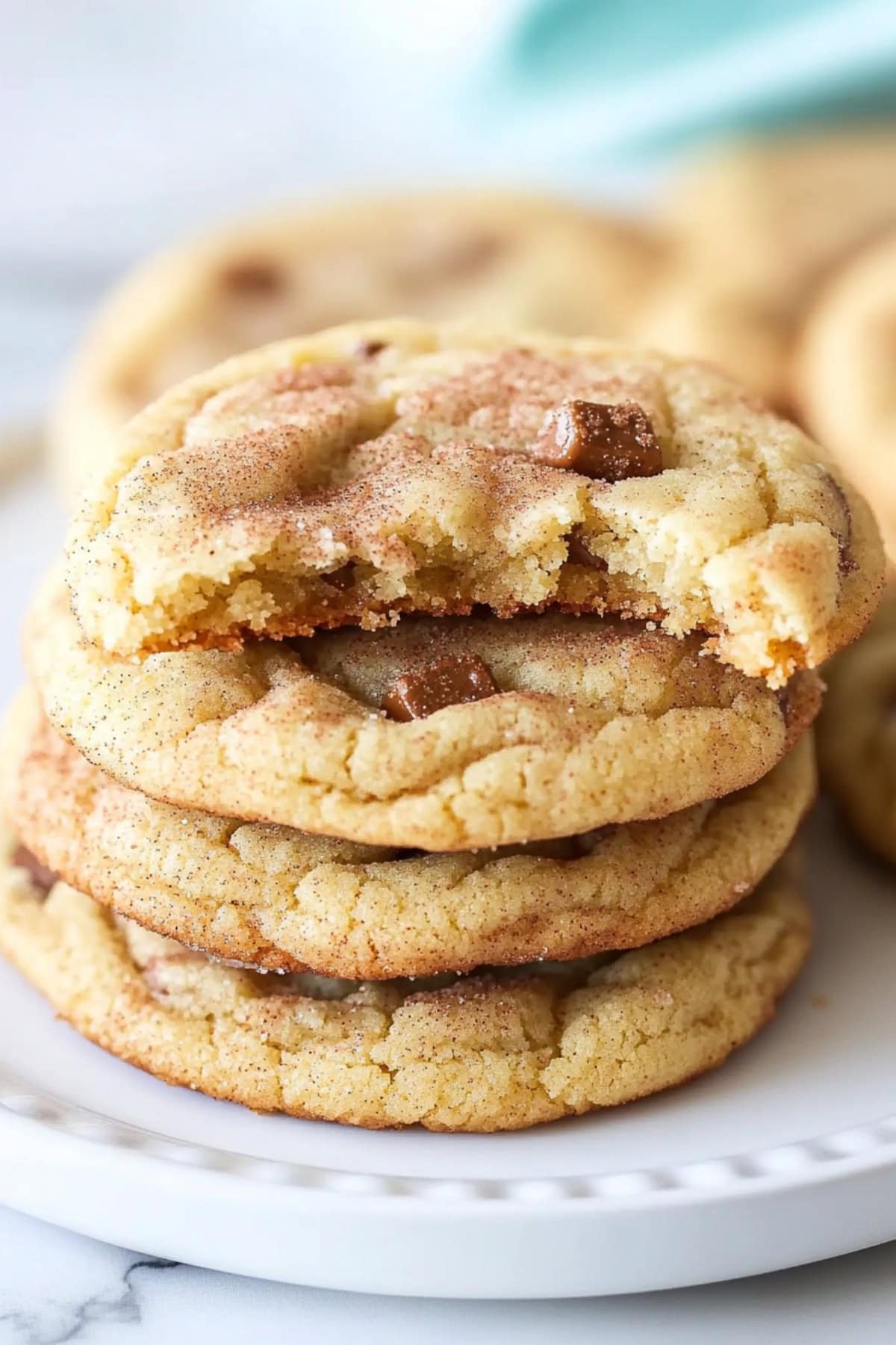 Buttery homemade toffee doodle cookies stacked on a plate, close up