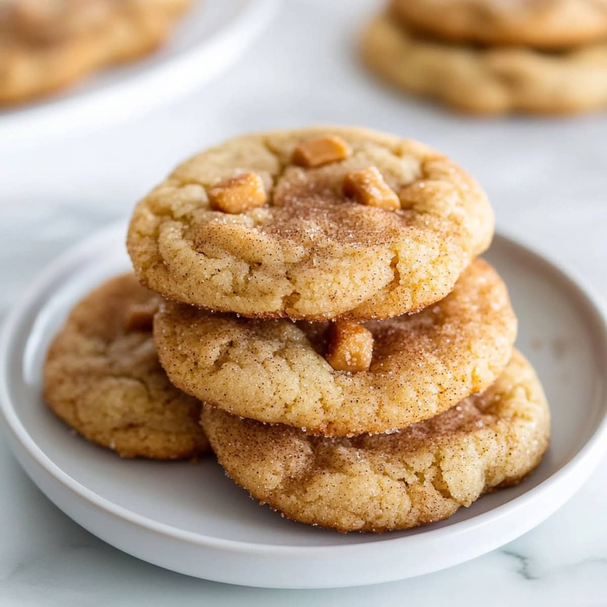 Close-up of soft, chewy toffee cinnamon cookies on a plate.