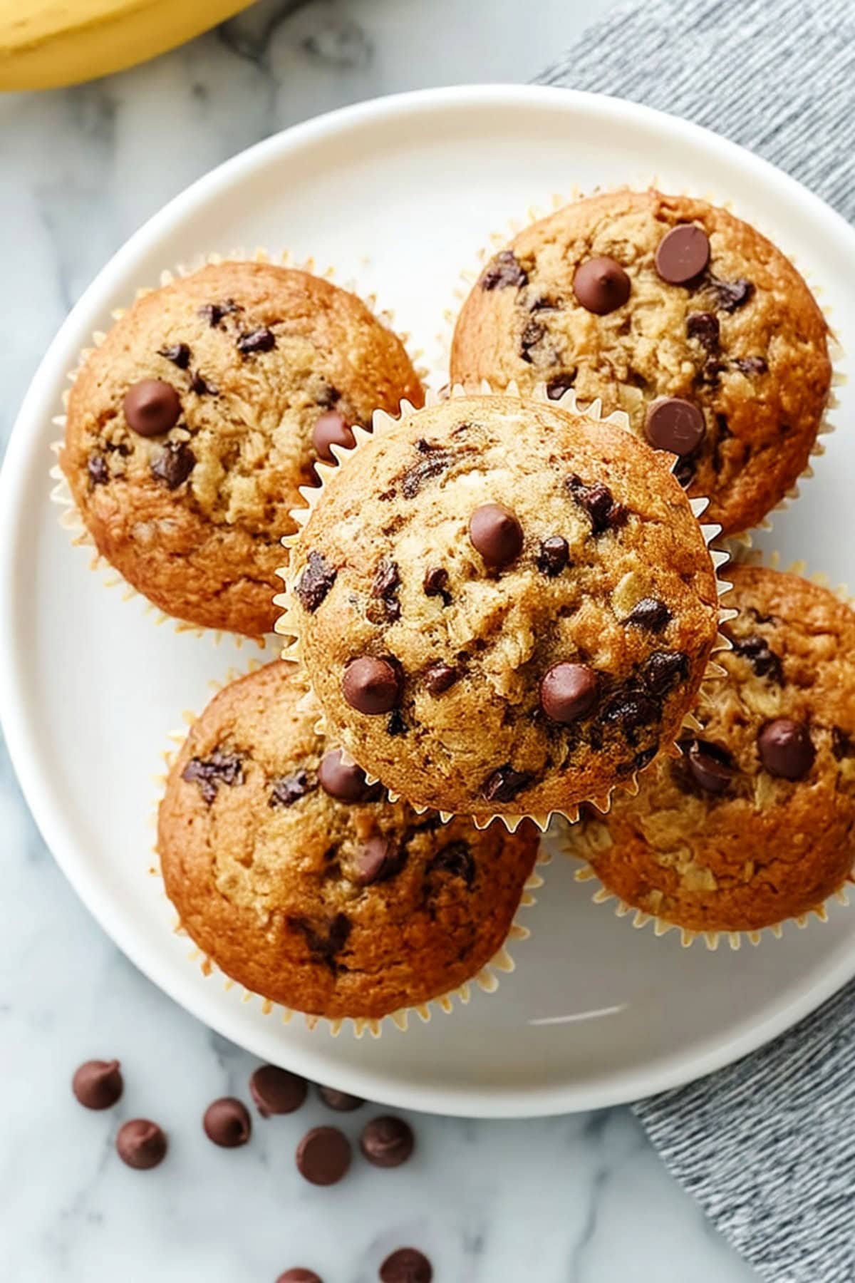 Banana Chocolate Chip Cupcakes on a plate, overhead close-up shot.