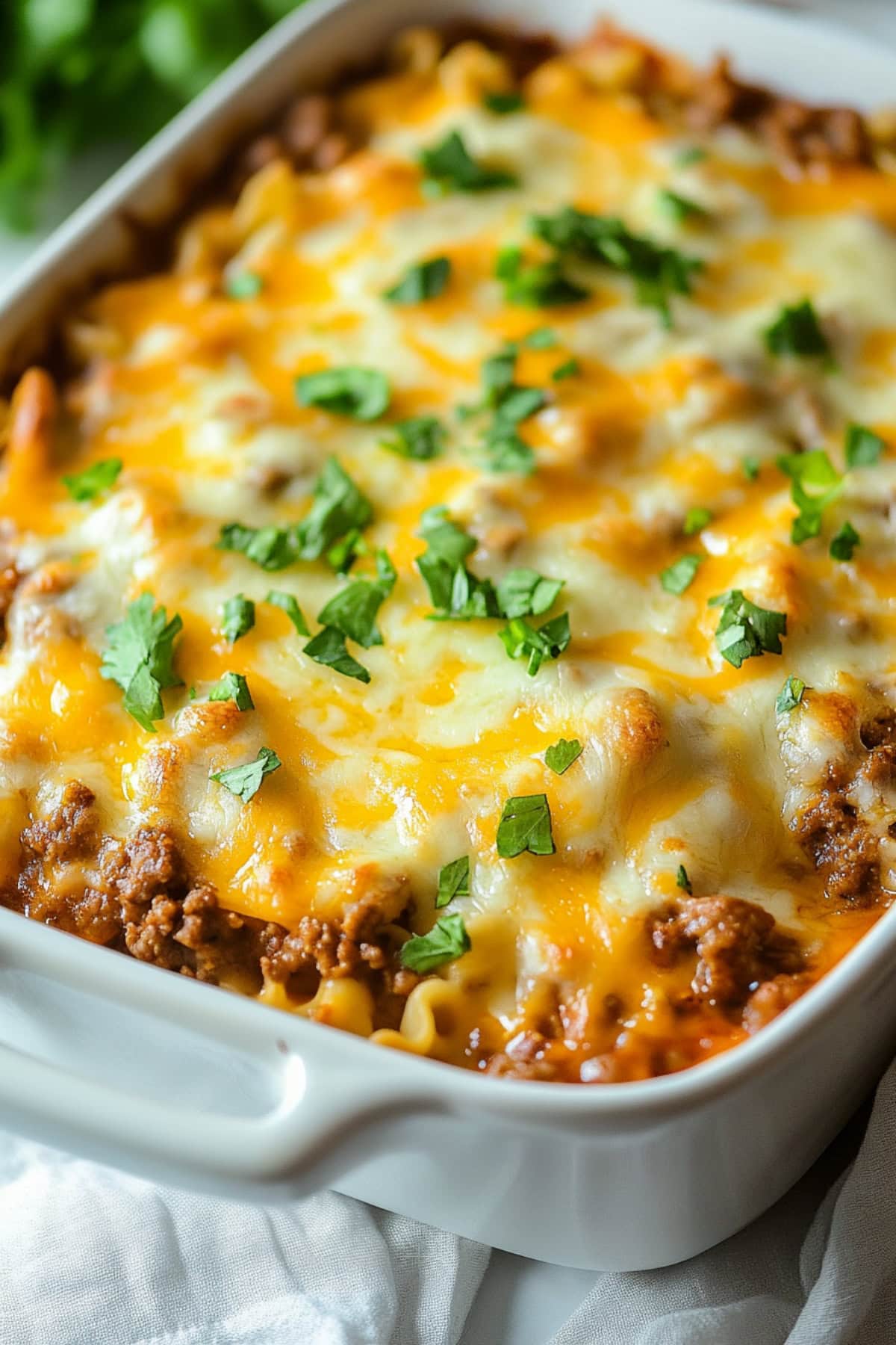 Beef lombardi casserole in a 9x13 white casserole dish.