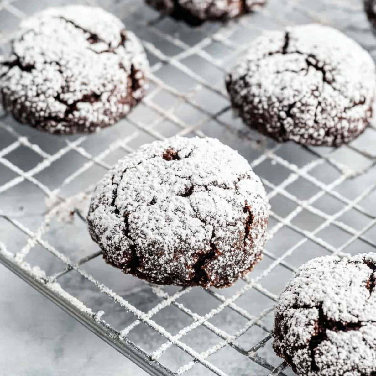 Brownie crinkle cookies in a cooling rack.