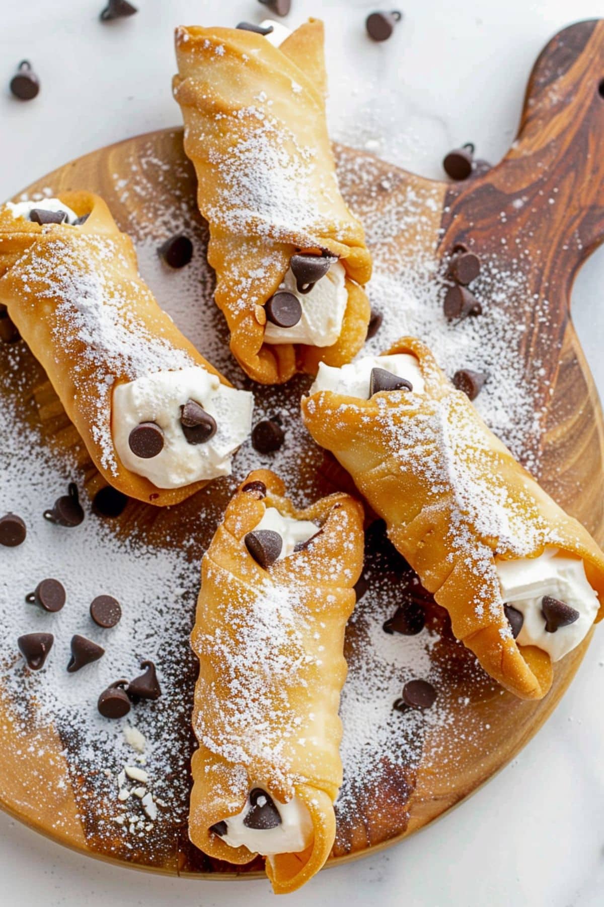 Bunch of cannoli with ricotta cheese filling with chocolate chips.