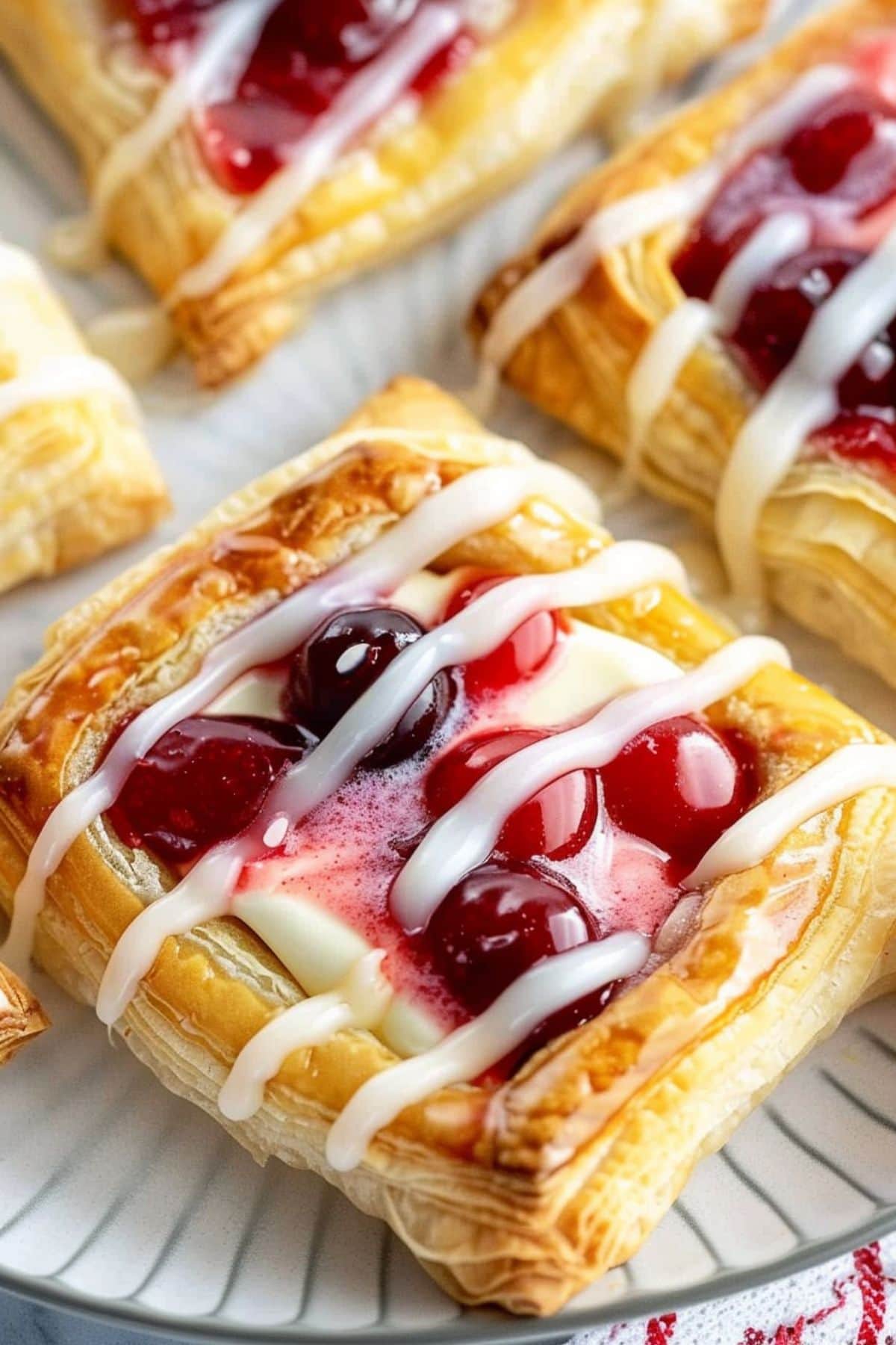 Cherry cream cheese Danish drizzled with sugar glaze on top.