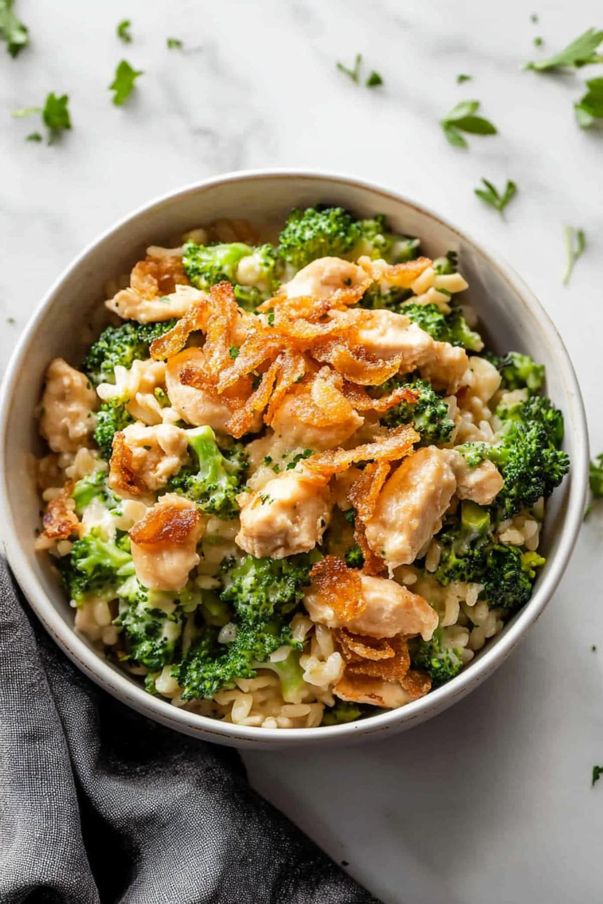 Cheesy chicken broccoli rice casserole topped with fried onions