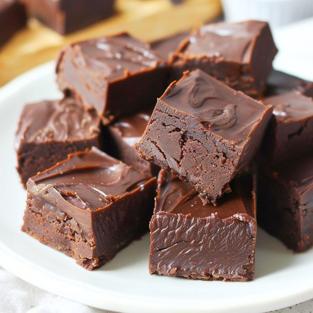 Chocolate fudge on a white plate.