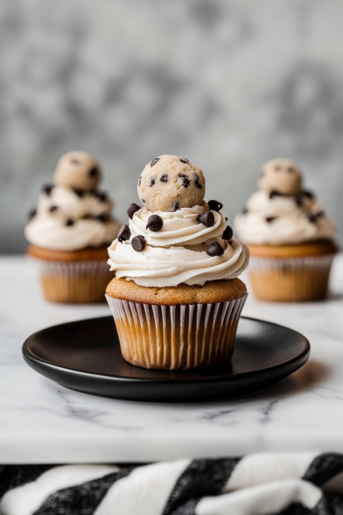 Delicious cookie dough cupcakes with a smooth, creamy brown sugar frosting and chocolate chips.