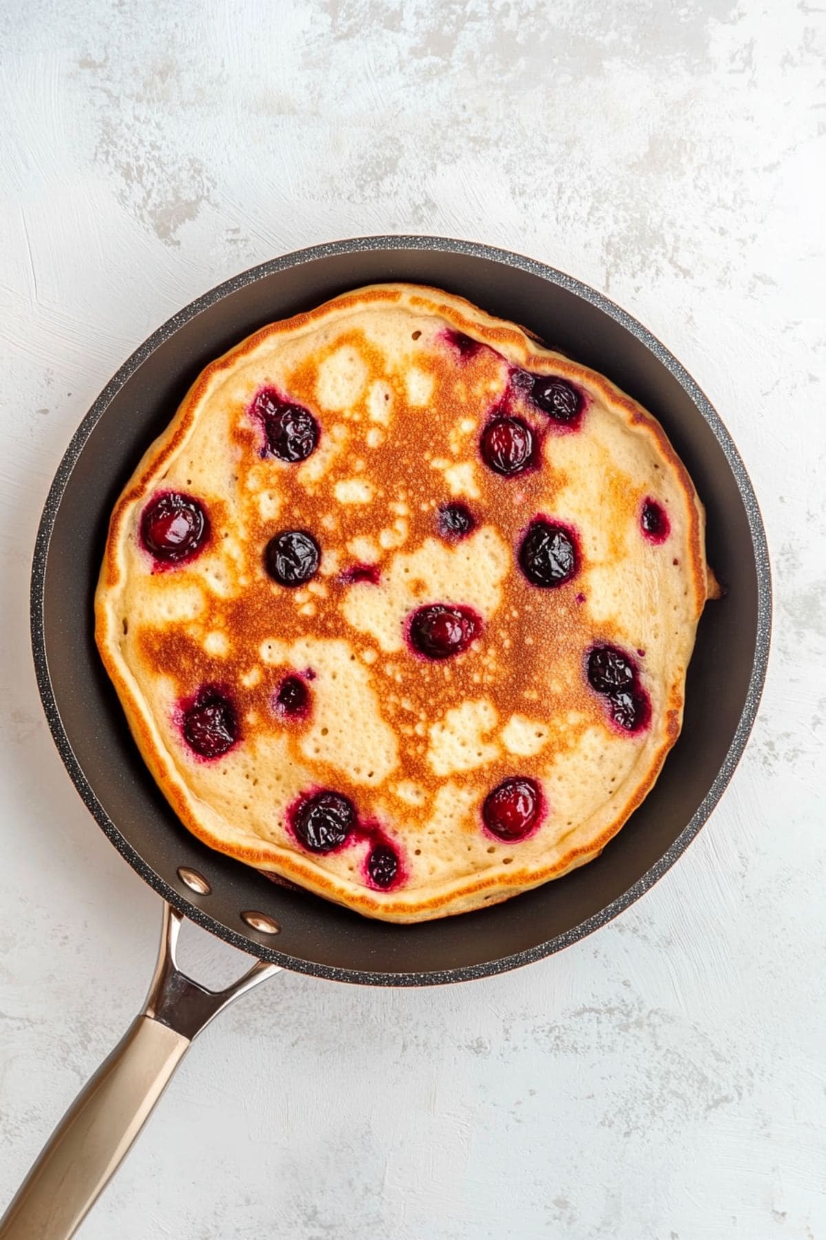 Pancake with cranberry in a pan. 