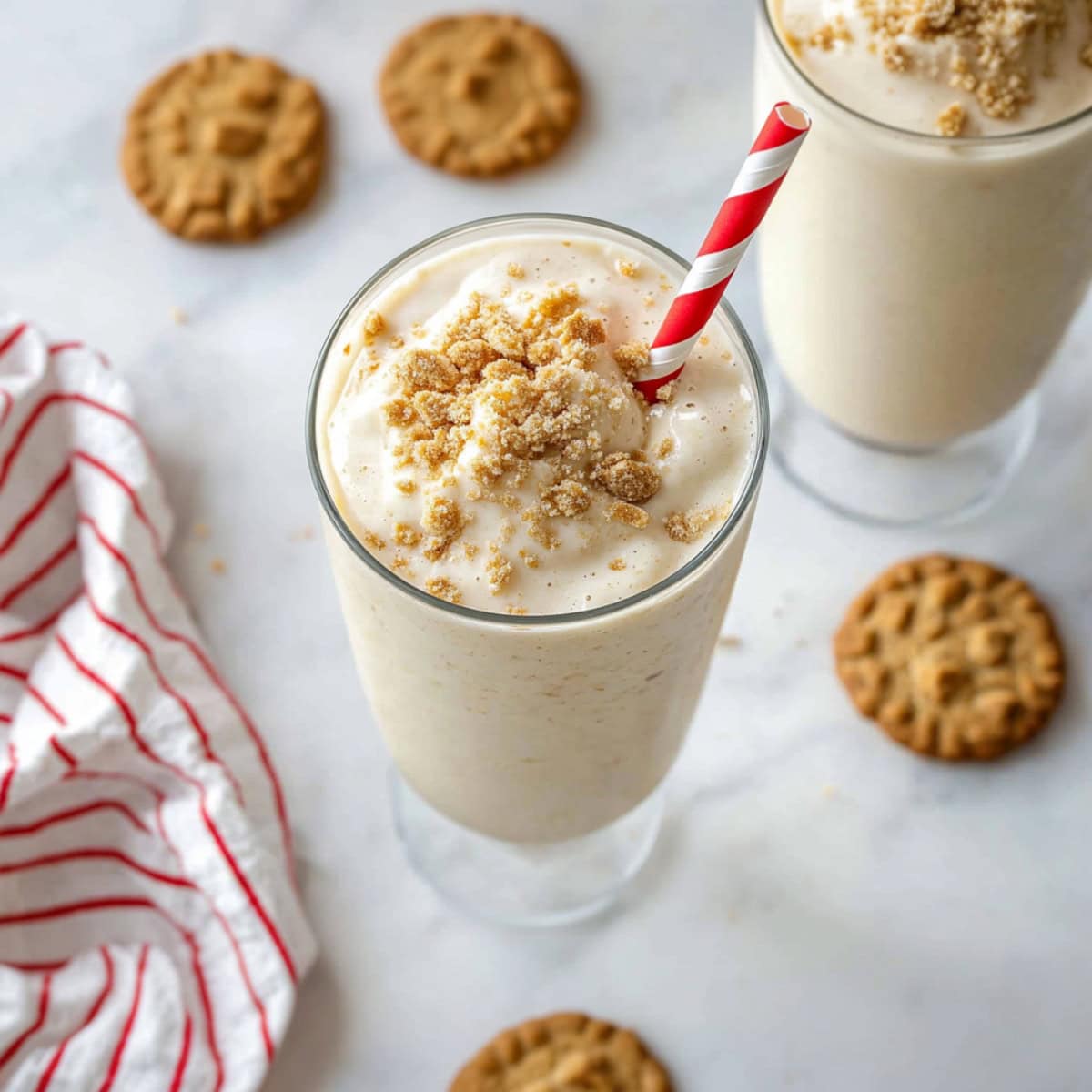 Homemade rich and creamy eggnog milkshake with crushed cookies.