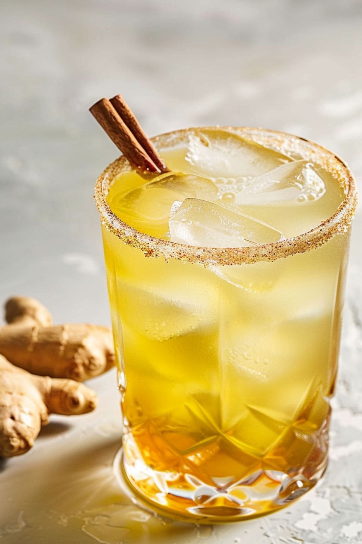 Refreshing gingerbread fizz served in a sugar rimmed glass garnished with cinnamon stick.