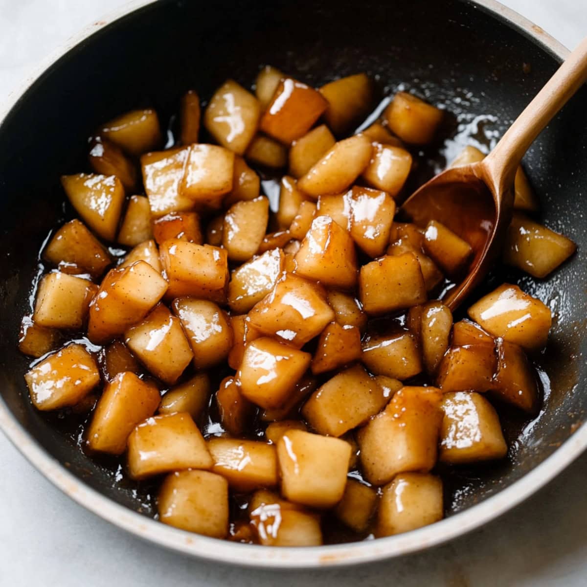 A saucepan of glazed apples, close-up.