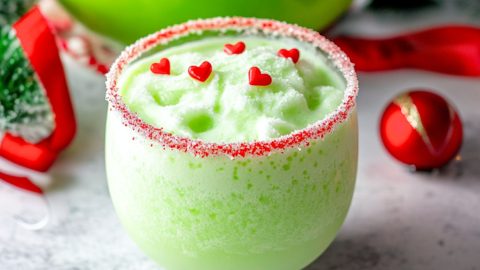 Grinch inspired punch drinks in a punch glass.