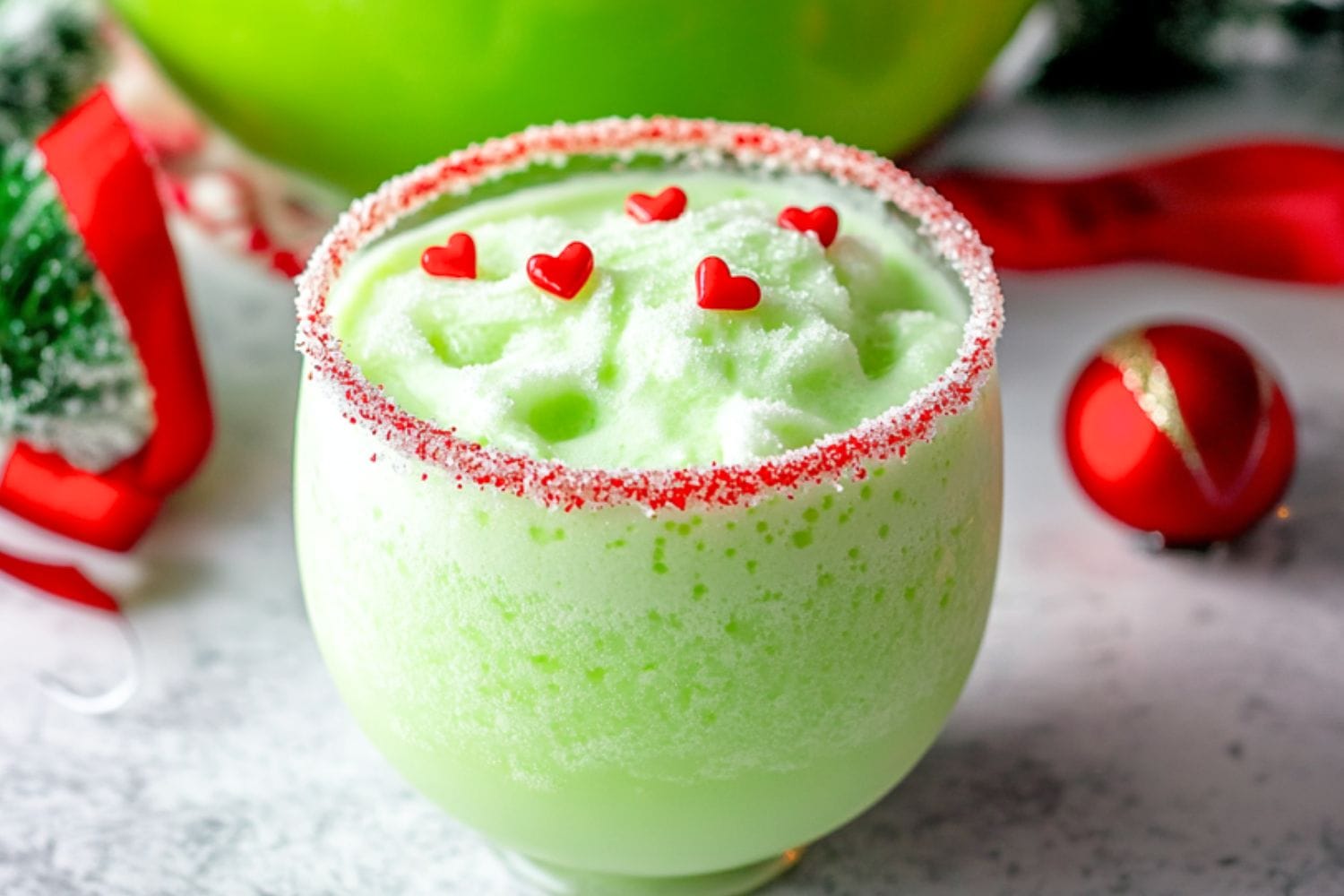 Grinch inspired punch drinks in a punch glass.