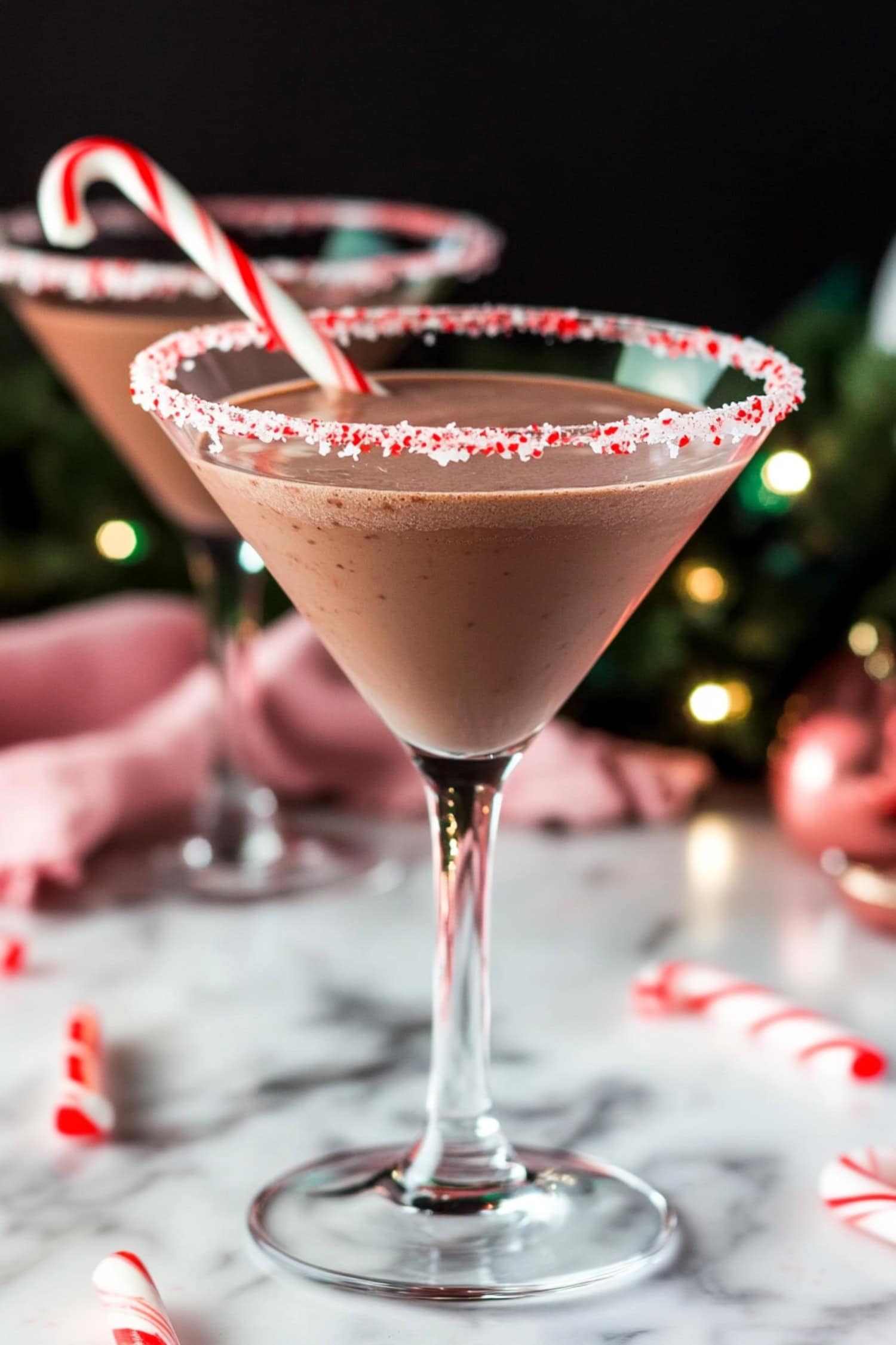 Festive chocolate peppermint mocktail served in a martini glass with candy cane garnish.