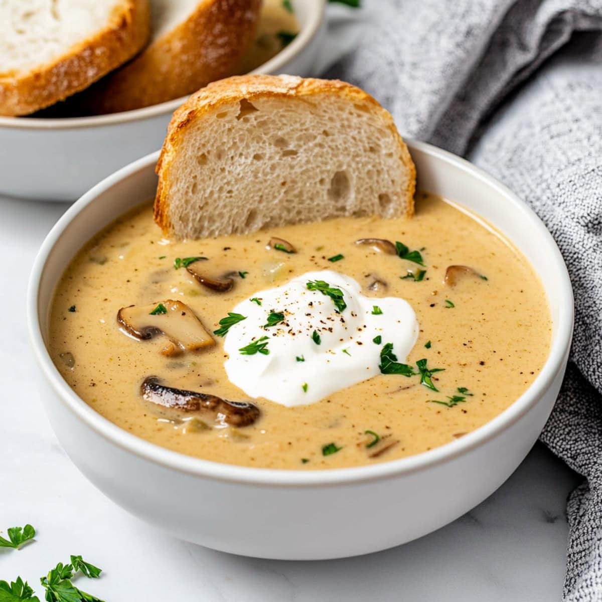 Creamy and velvety mushroom soup with sour cream, served in a bowl.