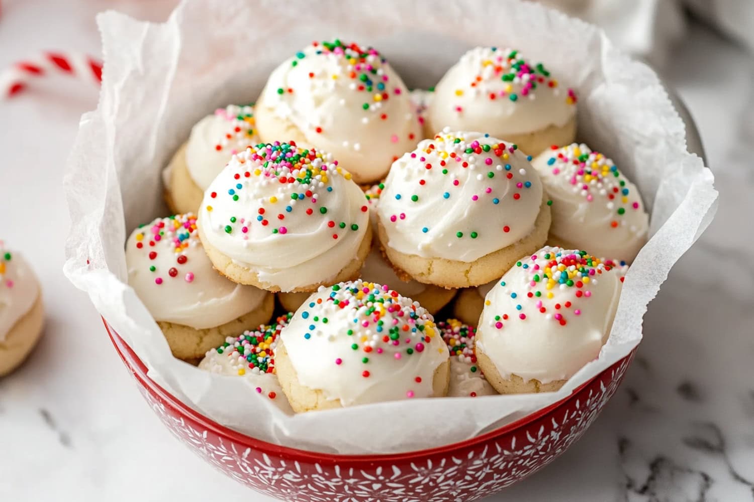 Italian ricotta cookies with a soft, moist crumb, topped with a sweet glaze and bright sprinkles for added color.