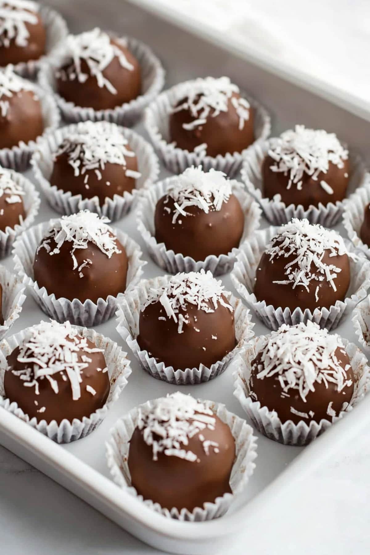 Close-up of a rich, chocolate-covered Martha Washington candy with a creamy, nut-filled center.