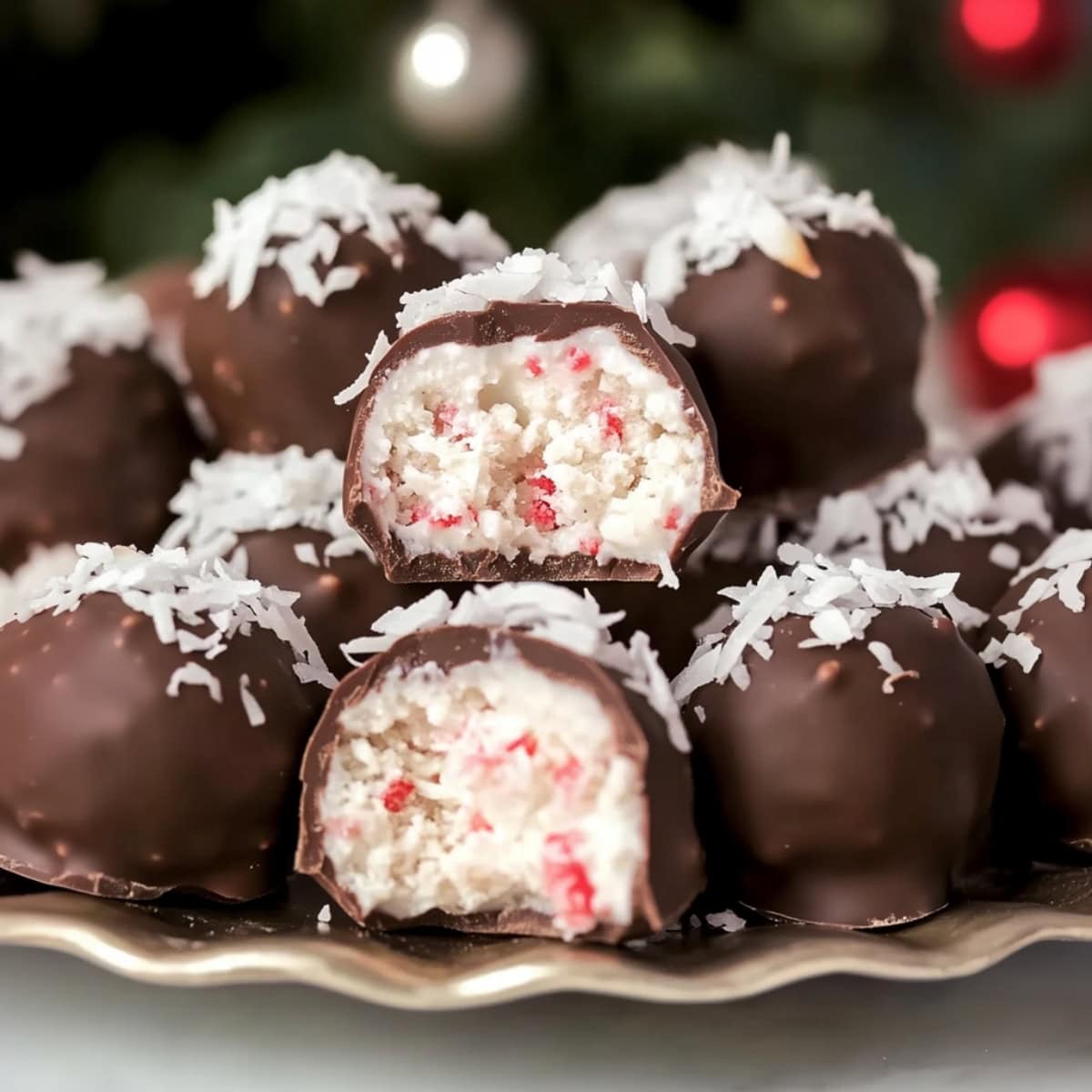 A stack of chocolate covered candy filled with coconut and cherries.