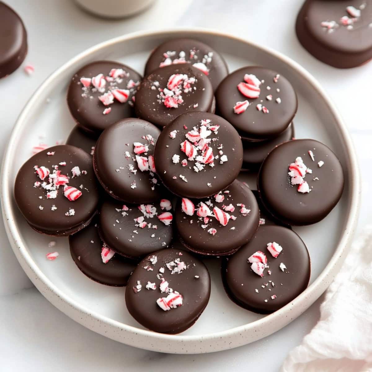 Chocolate covered peppermint patties in a white plate.