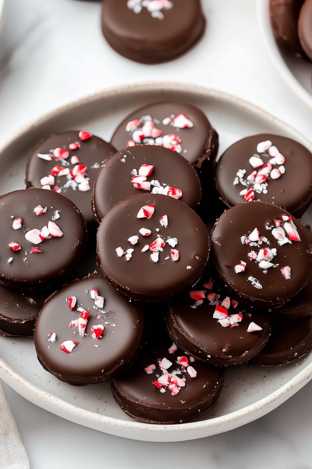 Peppermint patties with crushed candies in a plate.