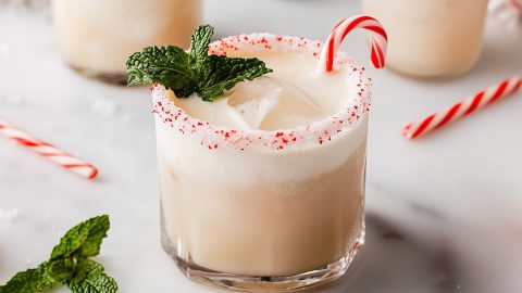 Creamy homemade white Russian drink with peppermint and mint in a glass.