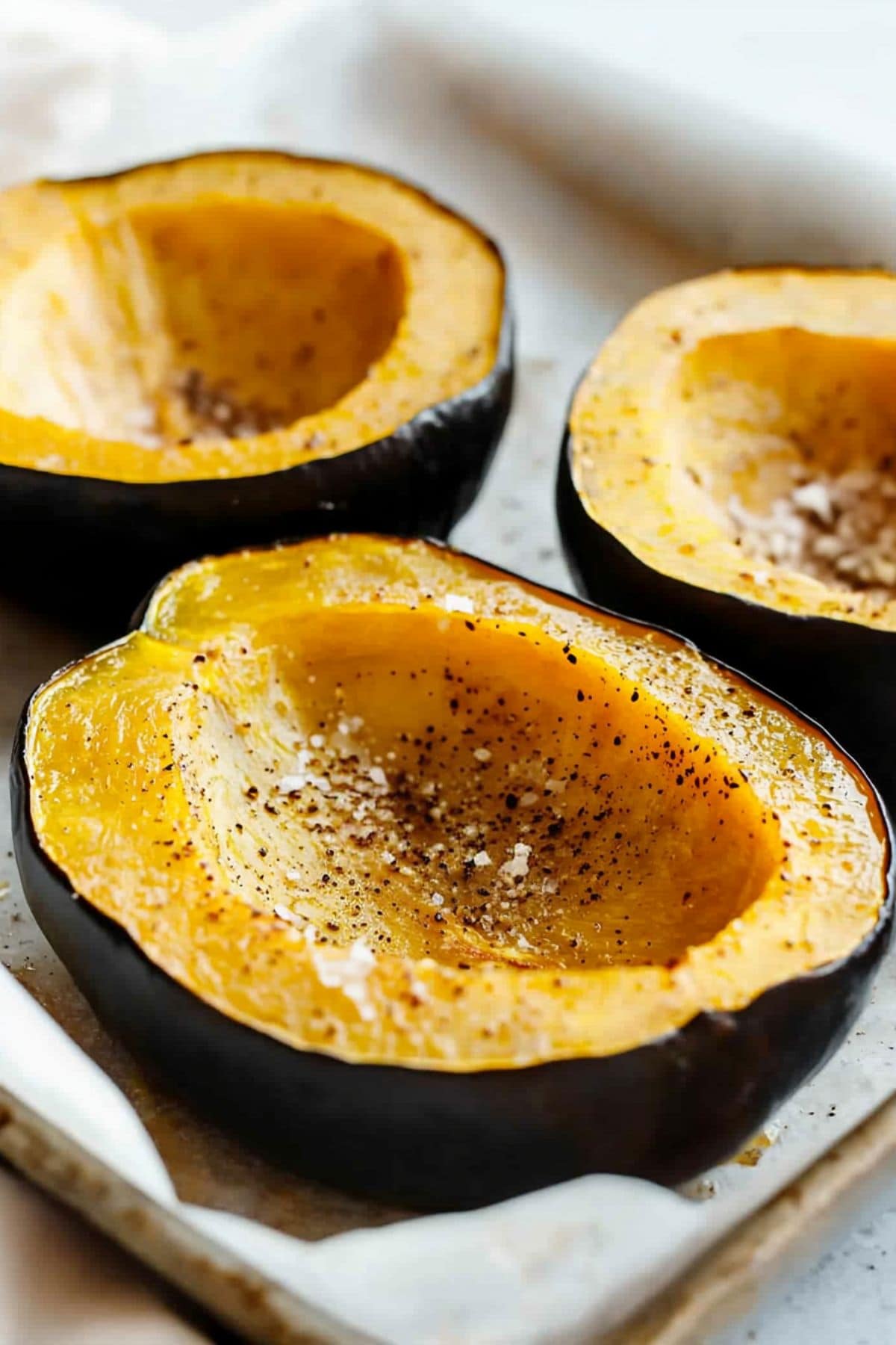 Roasted stuffed acorn in a baking pan. 