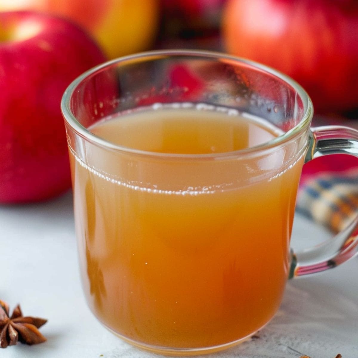 Apple cider drinks in a glass mug.