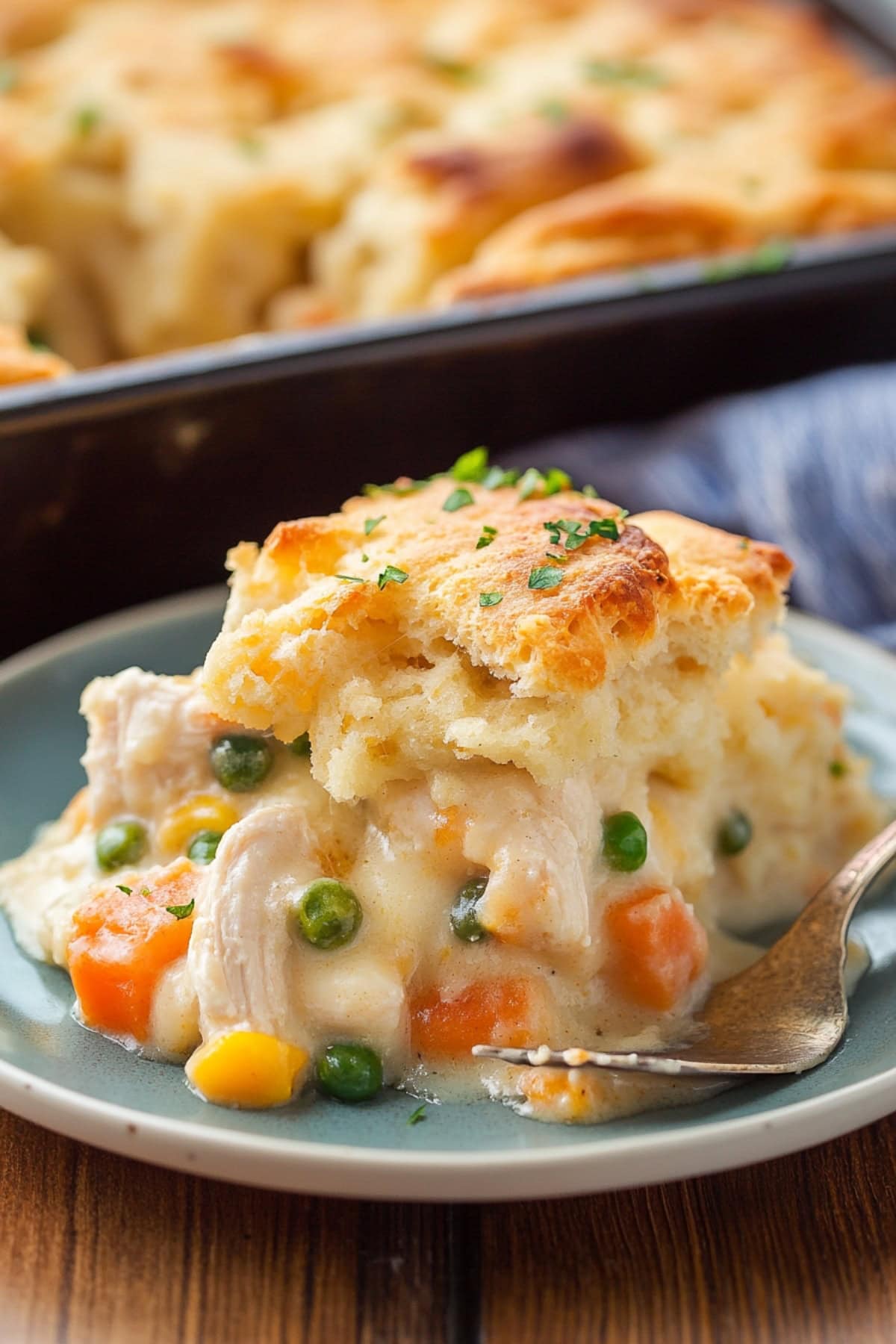 Serving of creamy cheddar bay biscuit chicken served in a white plate.