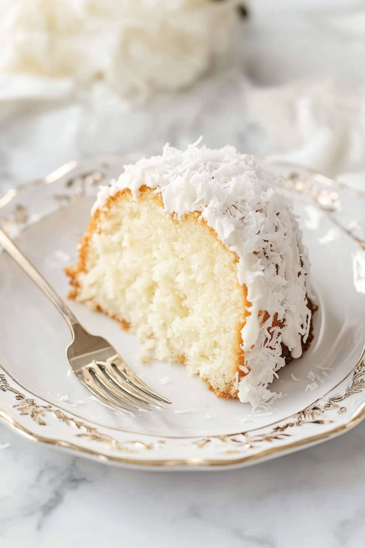 Homemade sliced Tom Cruise coconut cake in an elegant plate. 