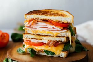 Cheesy tuna melt sandwich with turkey, bacon, tomato and cheese.