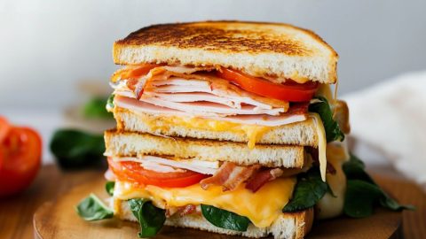 Cheesy tuna melt sandwich with turkey, bacon, tomato and cheese.