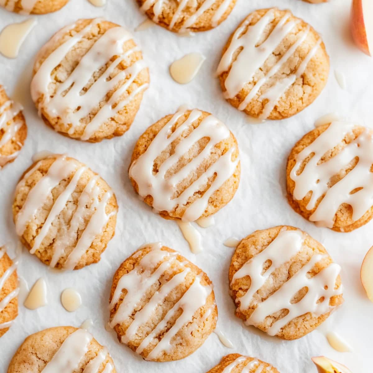 Close-up of soft and chewy apple cider cookies with a golden-brown finish and a hint of cinnamon.